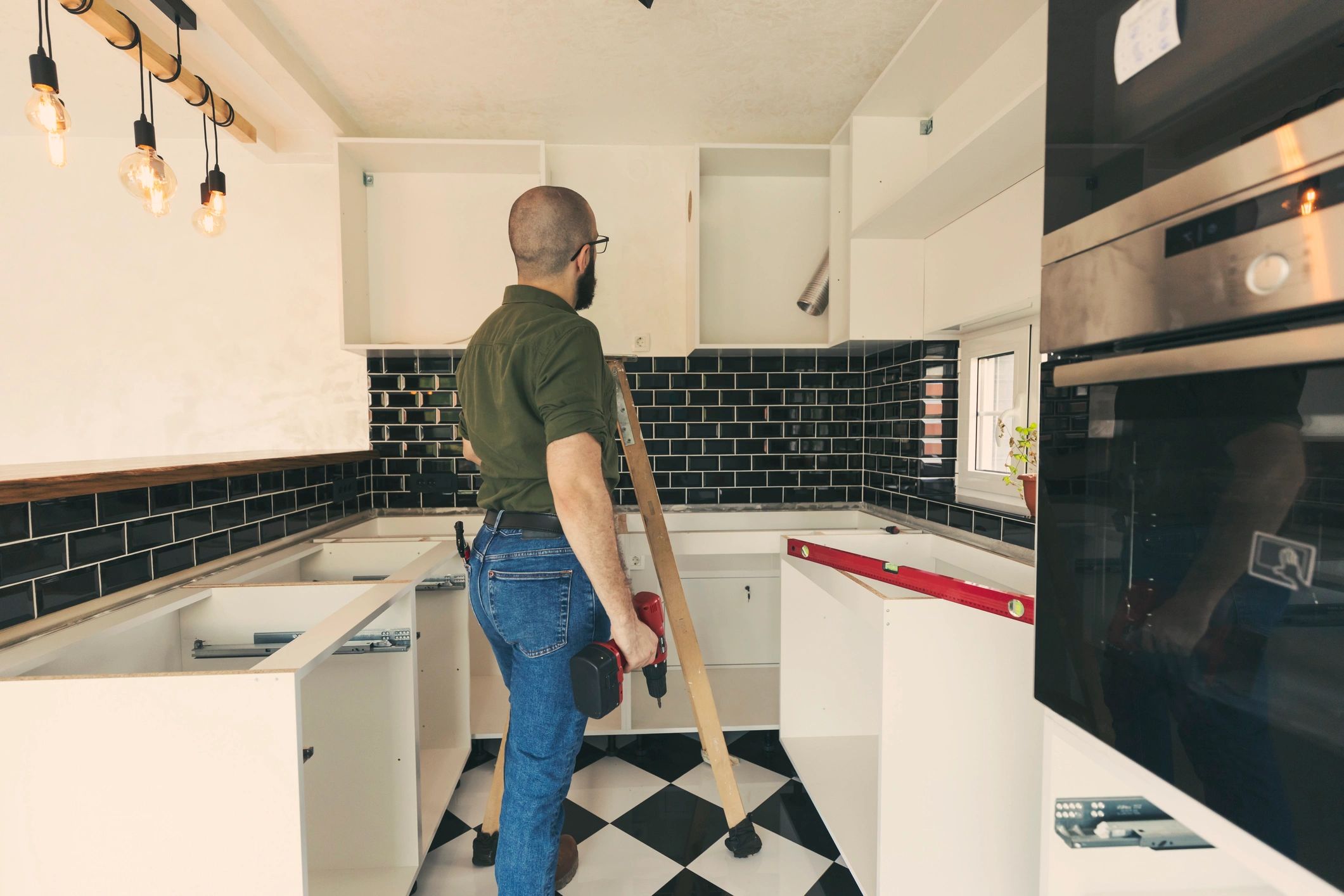 Plumber repairing a kitchen fixture