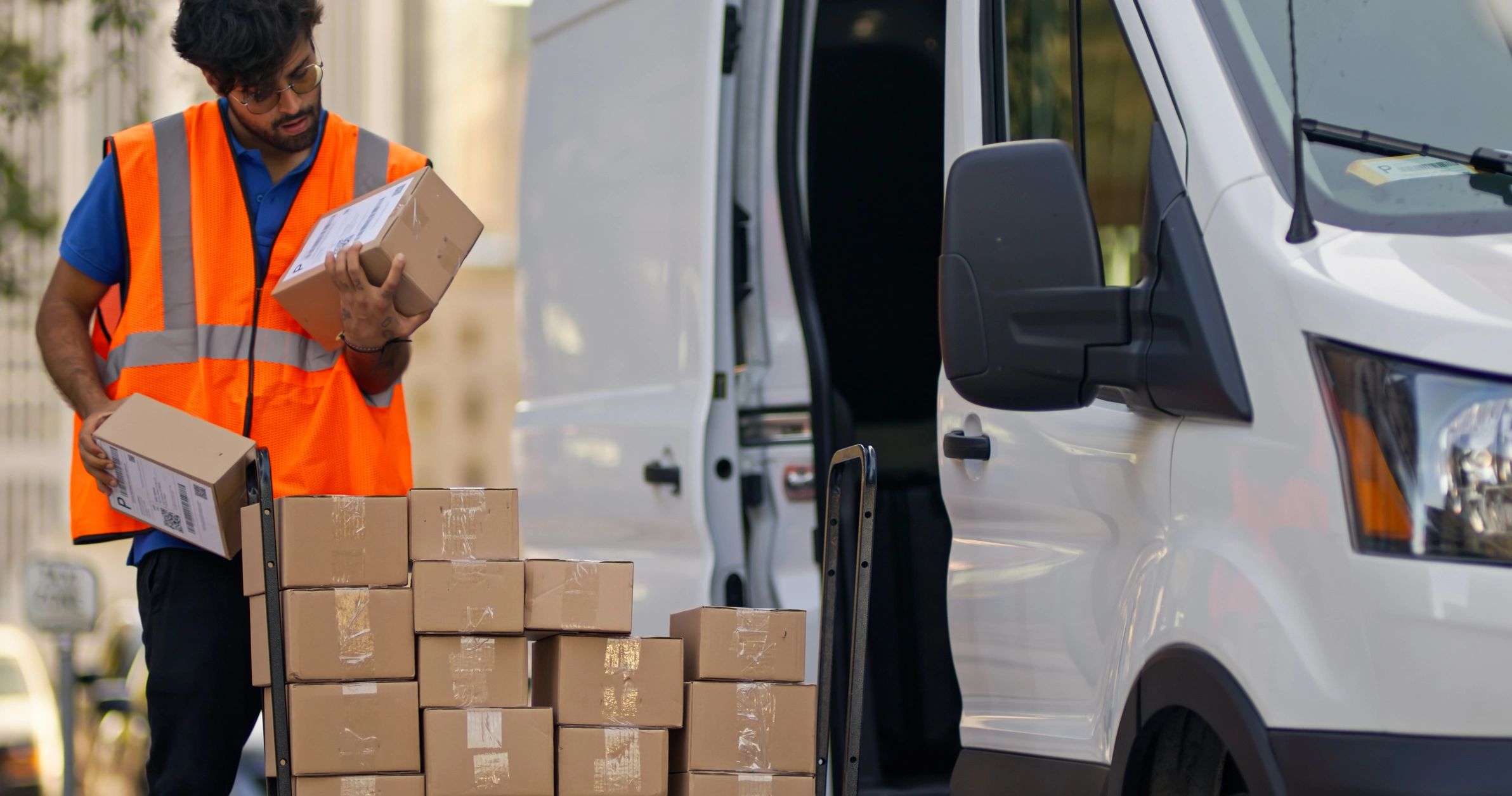 Service professional beside a work van